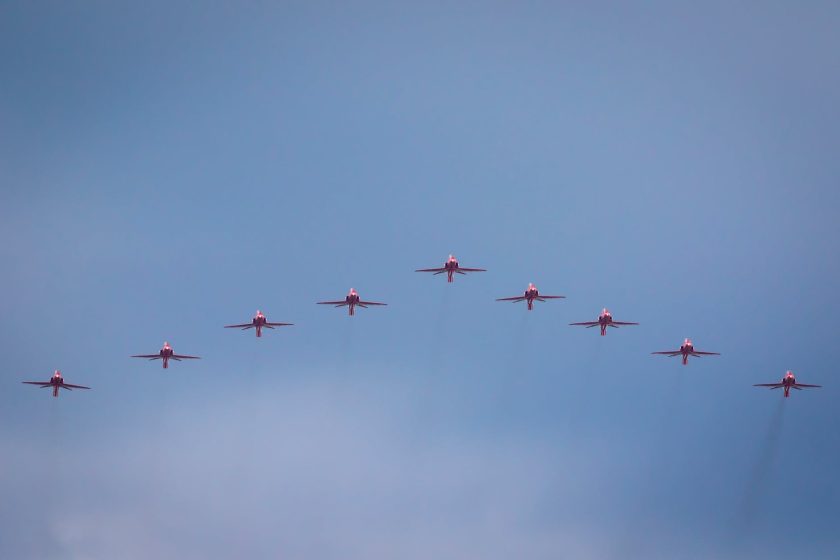 eight red jet planes in mid air